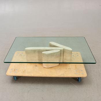 A glass and travertine coffee table later part of the 20th century.