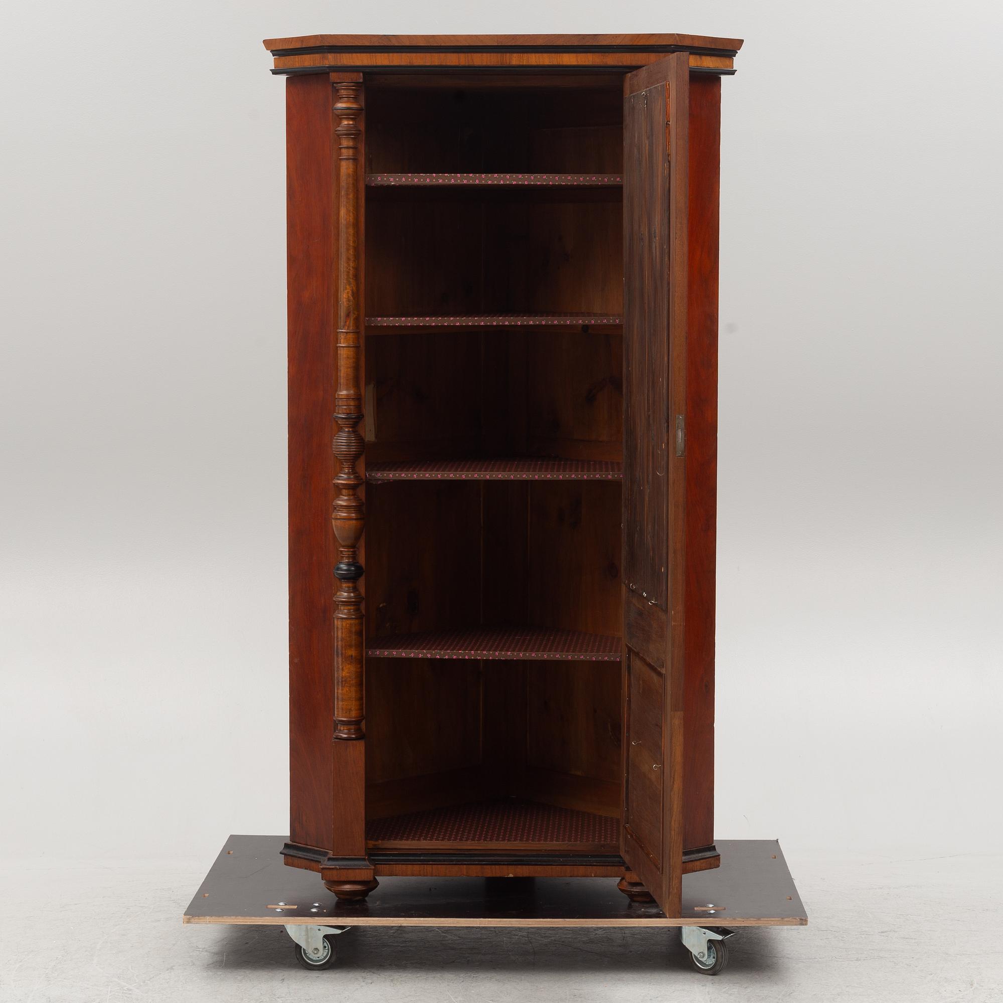 A corner cabinet, circa 1900.