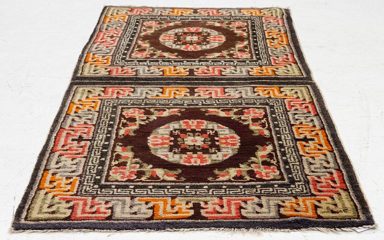 A Chinese two square rug, antique, c. 142 x 71 cm.