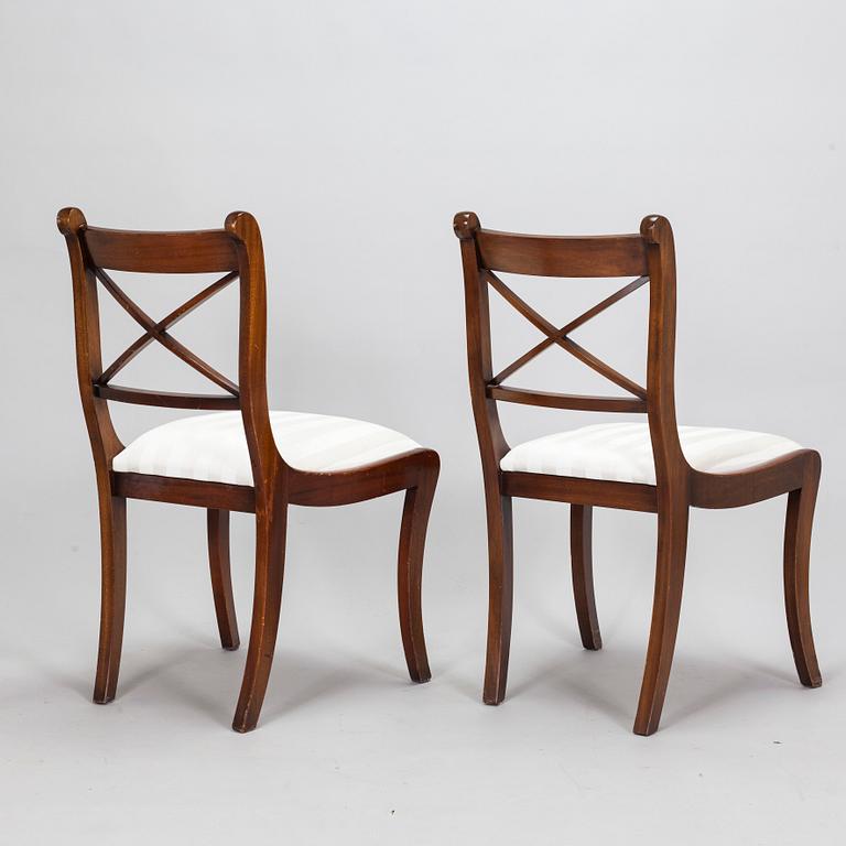 A dinner table and thirteen chairs, England, latter half of the 20th-century. Chairs marked Rosjohn,