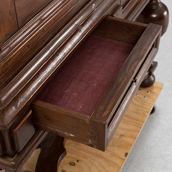 A stained pine Baroque cabinet, on a later stand. From around the year 1700.