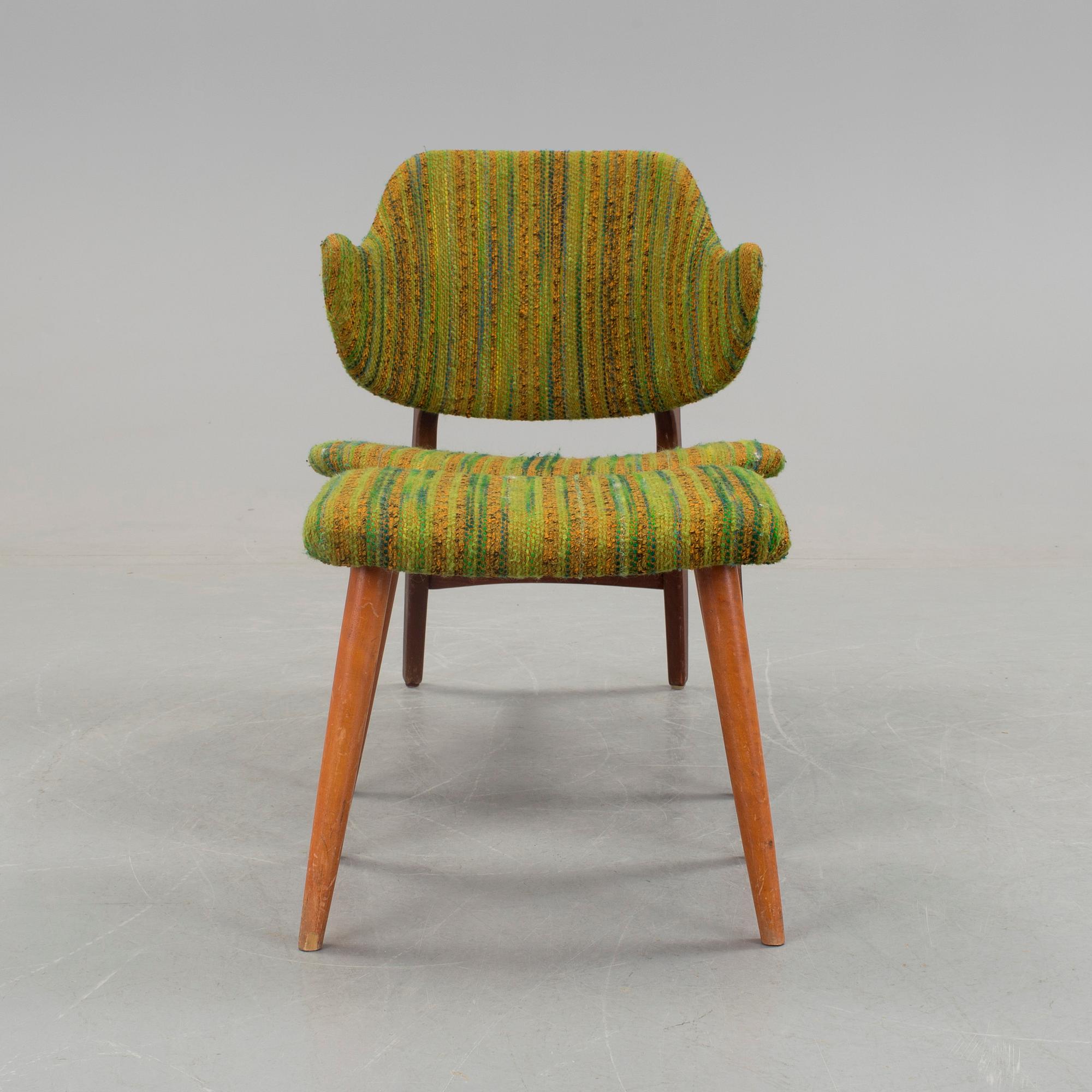 An IKEA armchair with a stool.