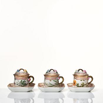 A set of 12 Royal Copenhagen 'Flora Danica' custard cups with covers and stands, Denmark, 20th Century.