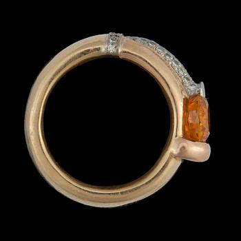 A orange sapphire, circa 2.67 cts, and diamond, 0.32 ct, ring.