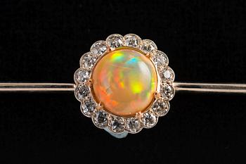 A BROOCH, Brilliant cut diamonds c. 0.65 ct, Opal 10 mm. 14K gold. Unmarked. Length 85 mm, weight 8,2 g.