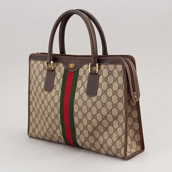 Gucci, a canvas handbag.