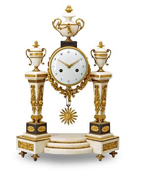 540. A Louis XVI late 18th century gilt bronze and marble mantel clock.