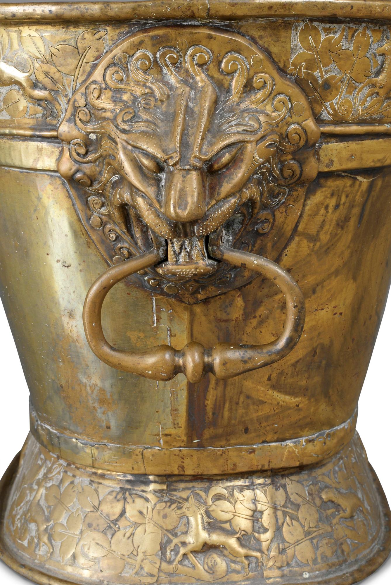A Baroque brass wine cooler.