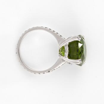 A 14.10 ct peridot and 0.78 ct brilliant-cut diamond ring.