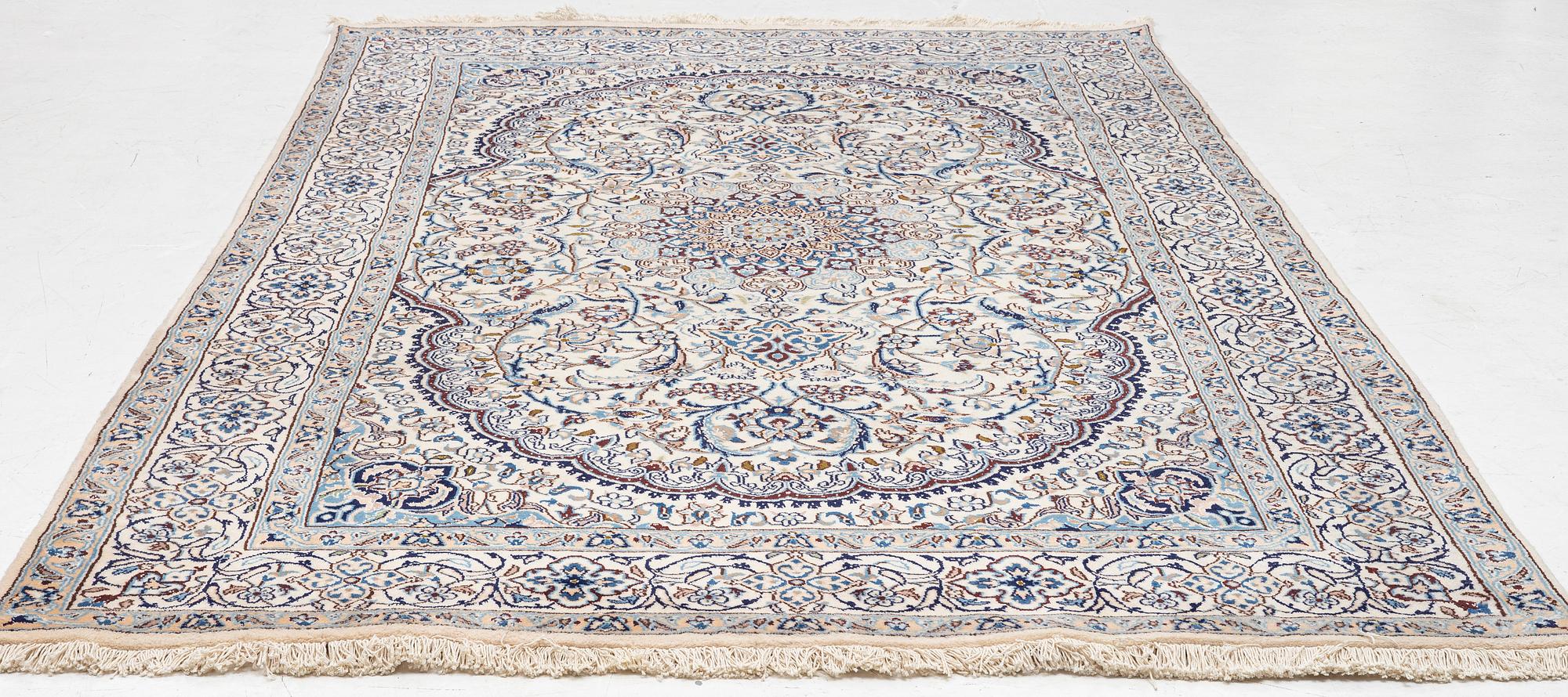A Nain carpet, c. 310 x 195 cm.