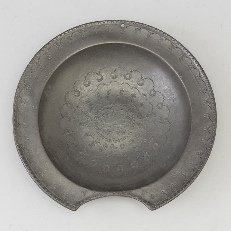 A 18th century pewter shaving bowl.