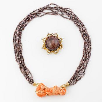 Multi-strand pearl necklace with two clasps set with carved coral, cabochon-cut tourmaline, and brilliant-cut diamonds.