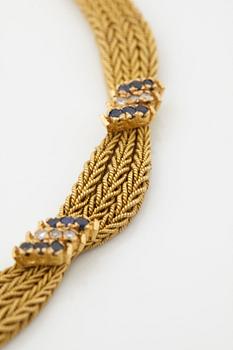 An 18K gold necklace set with eight-cut diamonds and sapphires.