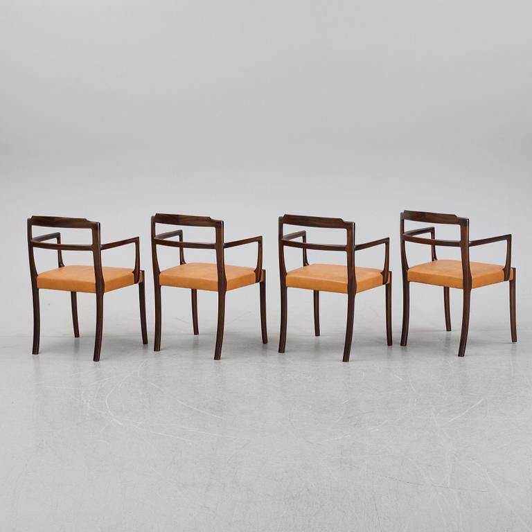 A set of four black stained beech tree arm chairs with leather upholstery, second half of the 20th century.