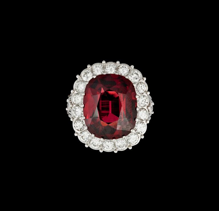 A natural red spinel, 11.15 cts, and diamond, circa 2.00 cts, ring.
