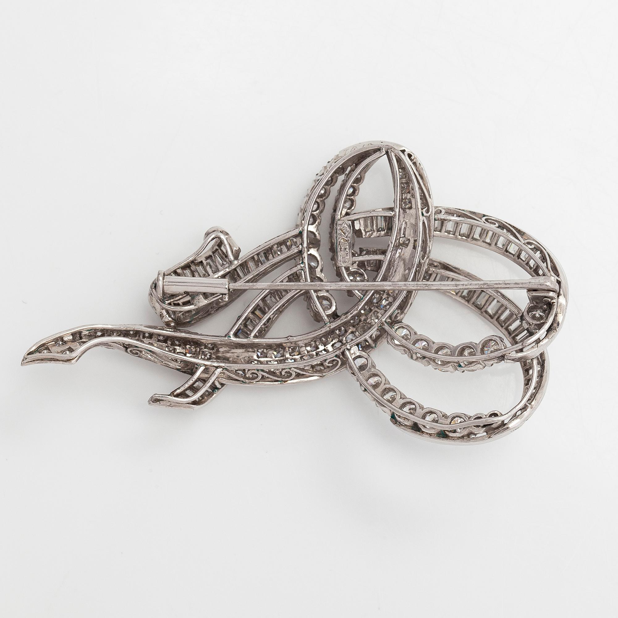 A platinum brooch, set with brilliant, baguette and eight-cut diamonds totalling approx. 7.21 ct. With certificate.