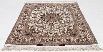 A semi-antique Isfahan rug, central Persia, signed Ghaffarian, c. 180 x 112 cm.