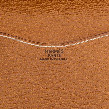 Hermès, a brown leather case for sunglasses.