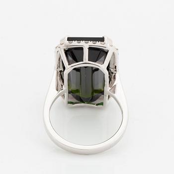 An 18K white gold ring set with a step-cut green tourmaline and round brilliant-cut diamonds.