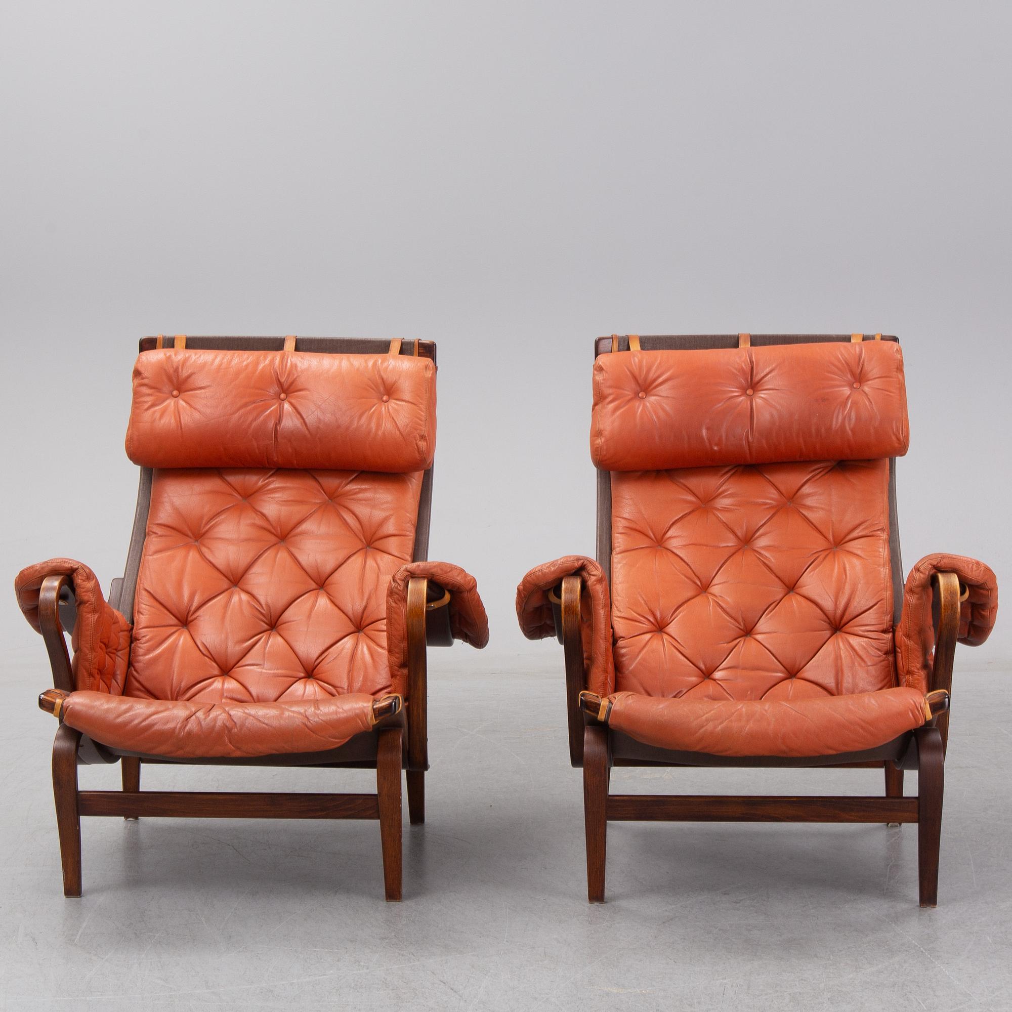 An end of the 20th Century pair of 'Pernilla' easy chairs with leather upholstery by Bruno Mathsson for DUX.