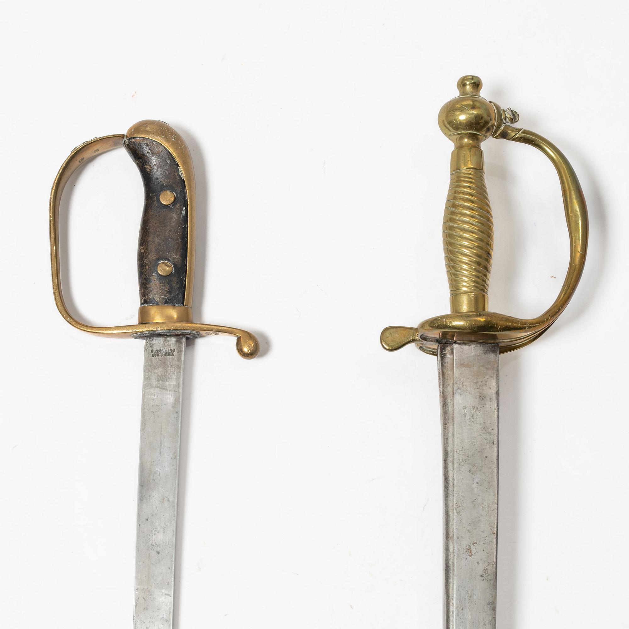 A Swedish police sabre and cutlass, with scabbards.