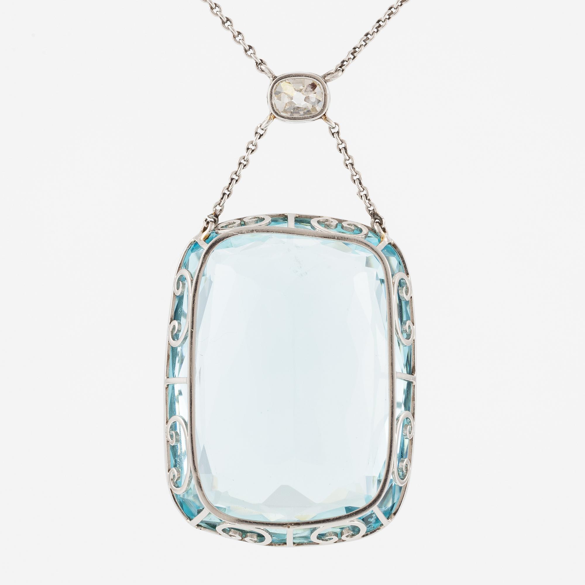 A platinum necklace with a faceted aquamarine and an oval old-cut diamond.