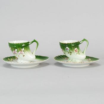 A pair of Russian porcelain cups and saucers, Kuznetsov, circa 1900.