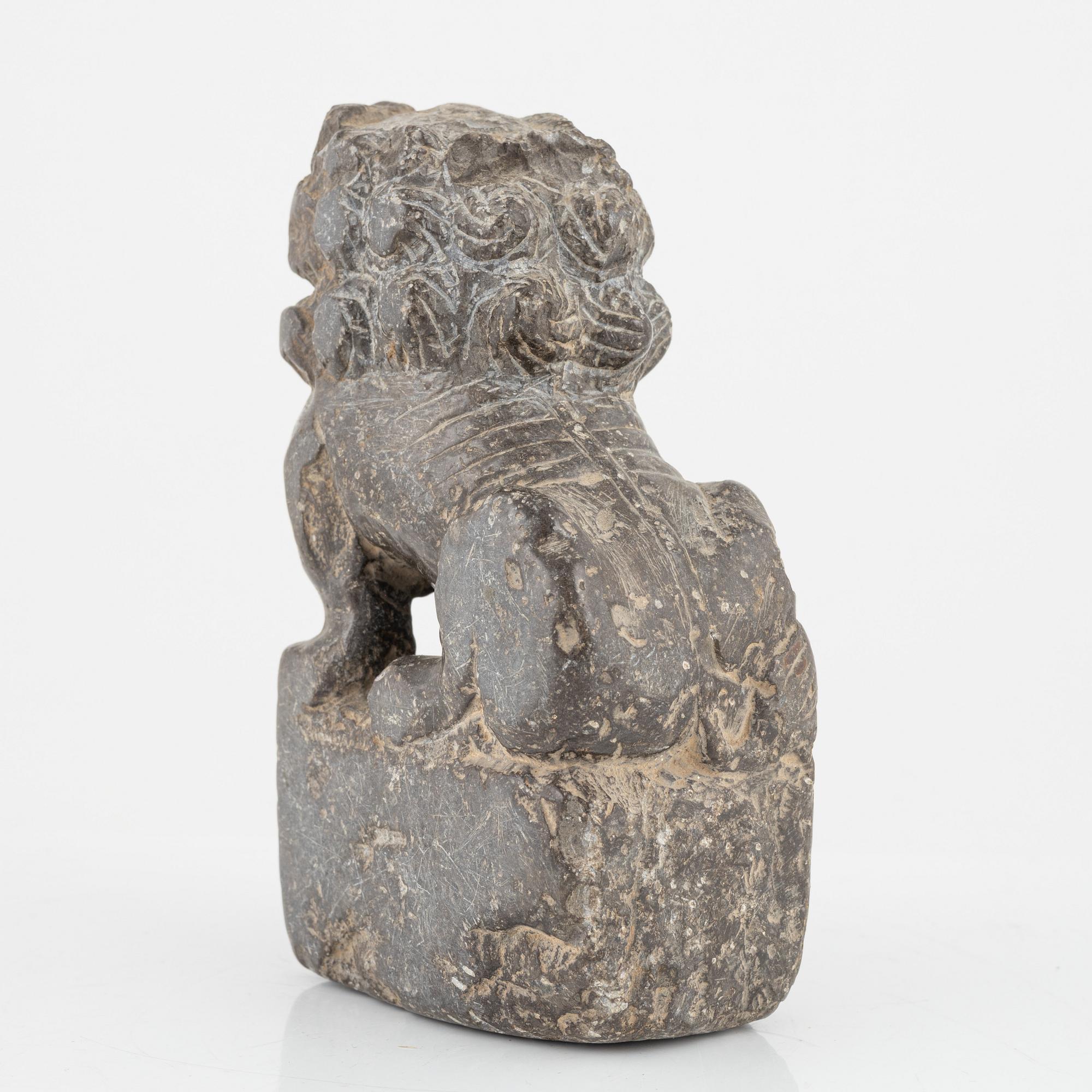 A stone scroll weight/sculpture of a buddhist lion, China, presumably Qing dynasty (1664-1912).