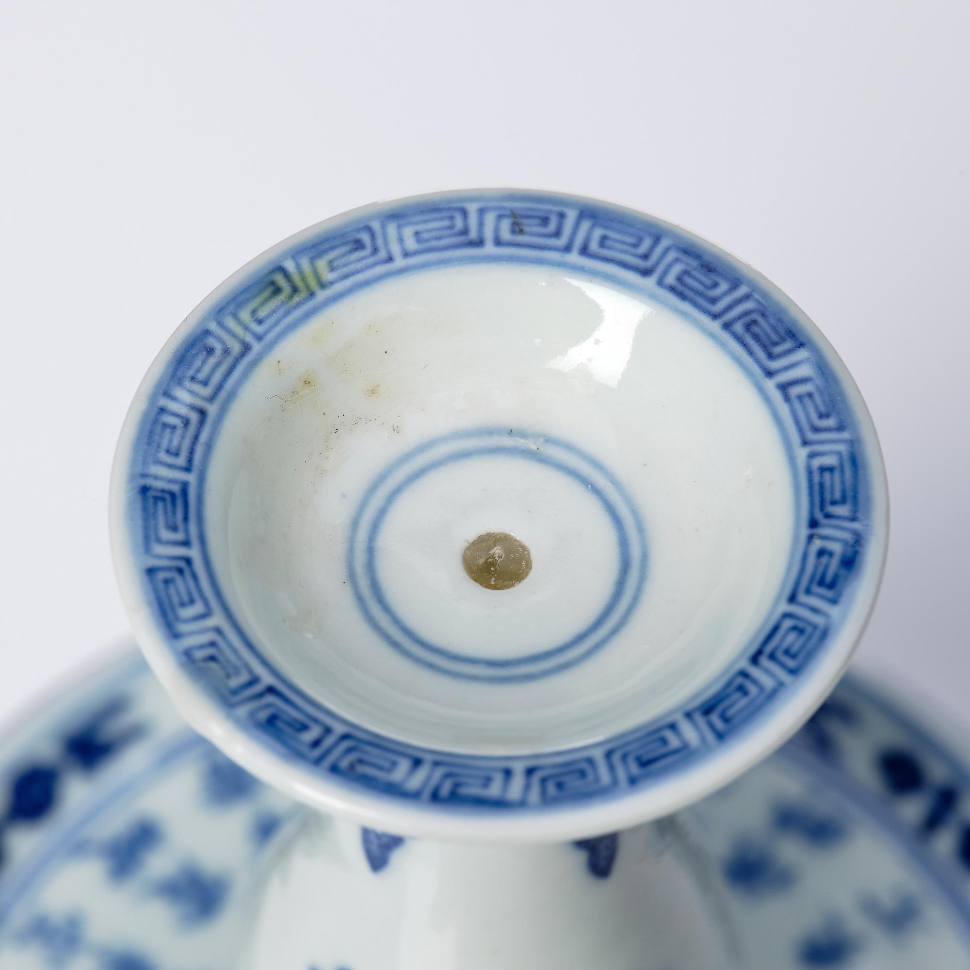 A pair of blue and white pricket candle sticks, with a poem, Qing dynasty with a Qianlong mark and of the period.