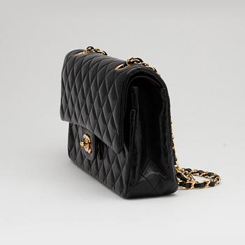 CHANEL, a quilted black leather "Double Flap" shoulder bag.