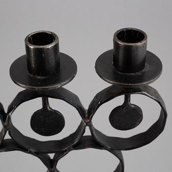 A cast iron candelabra by Bertil Vallien for Kosta Smide, Sweden.
