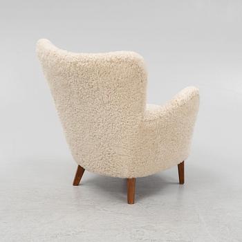 A lounge chair with new sheepskin upholstery, Sweden, second part of the 20th Century.
