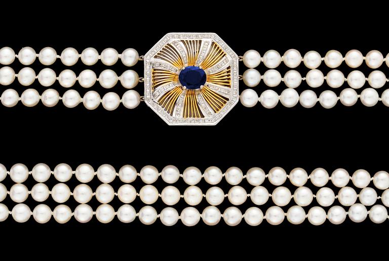 A cultured threestrand pearl necklace with 18k gold sapphire and diamond clasp.
