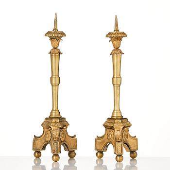 A pair of presumably Italian Empire ormolu candlesticks, early 19th century.