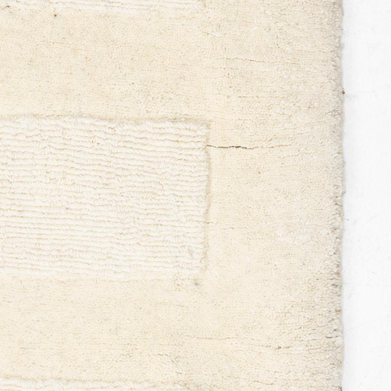 A hantd tufted carpet, 'Entrance - bone white' by Layered, ca 400 x 300 cm.