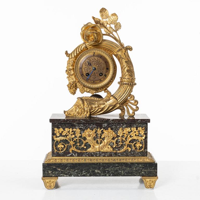 A presumably French Empire-style gilt bronze and marble mantel clock, later part 19th century.