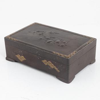 A japanese meji steel box with gold inlays and lid decorated with turtles and frogs. Signed.