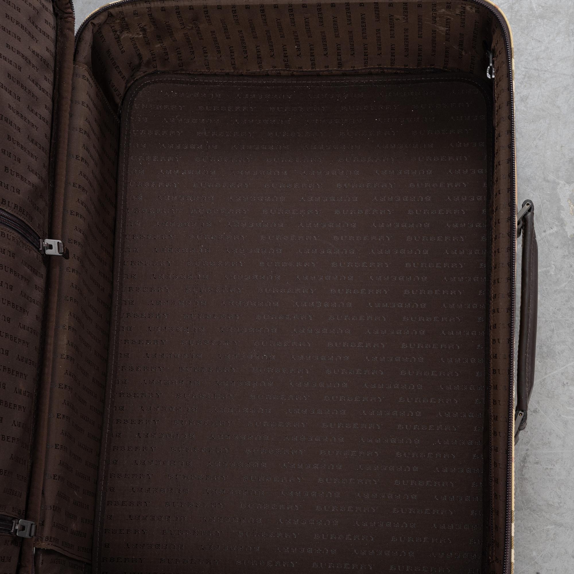 Burberry, a Nova Check canvas suitcase.