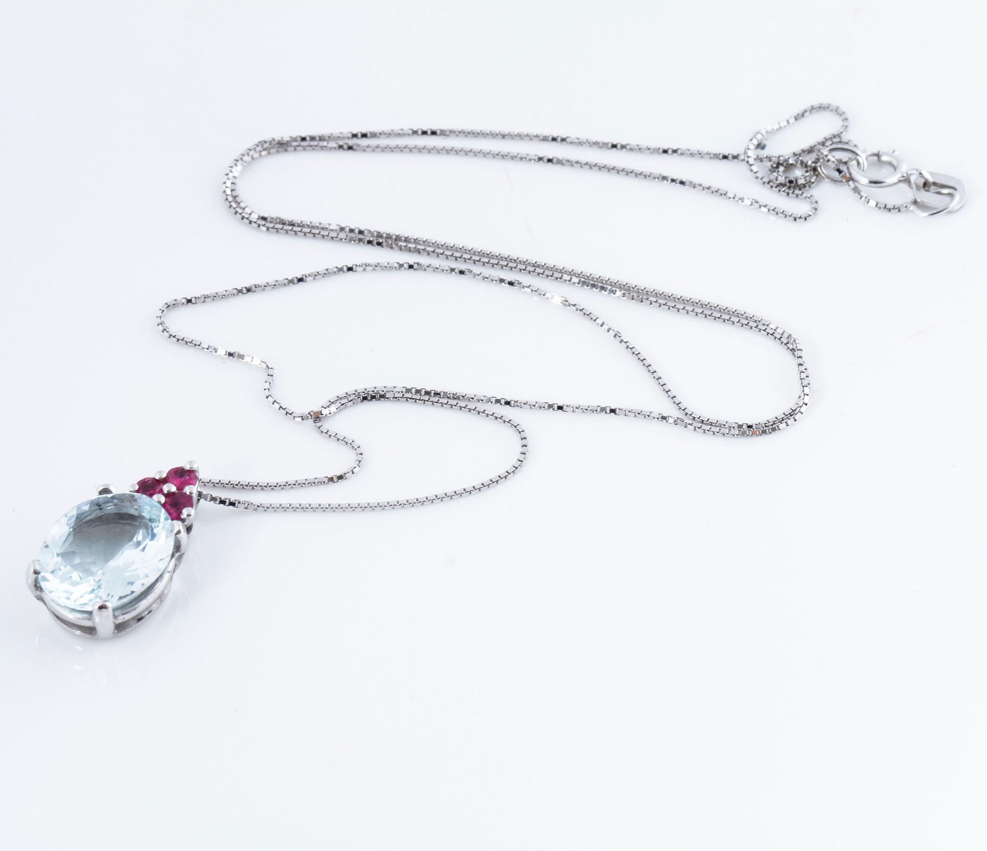 A aquamarine and ruby pendant.
