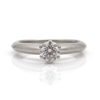 A ring set with a round, brilliant-cut diamond by Tiffany & Co.