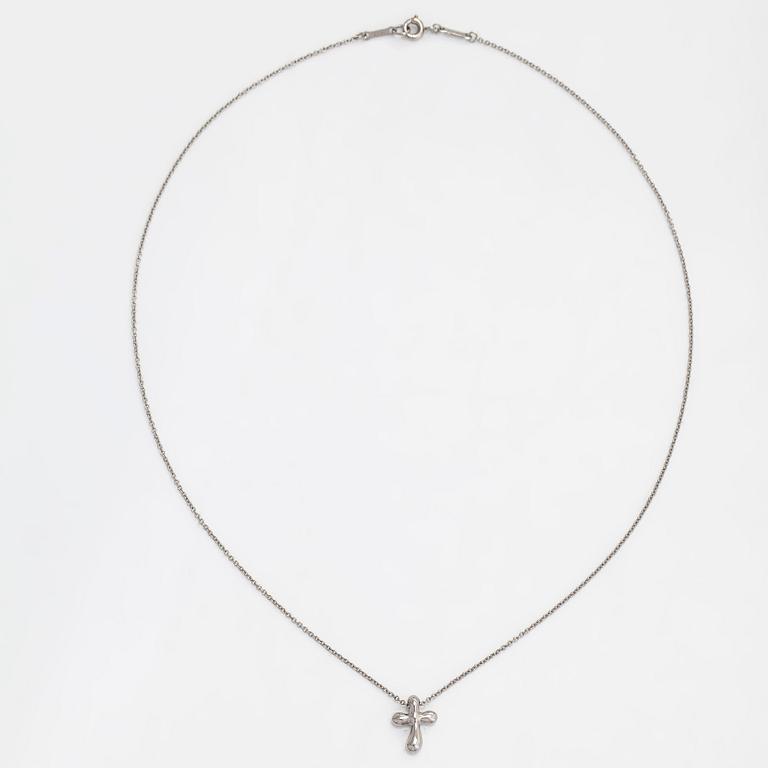 Tiffany & Co, Elsa Peretti, a platinum cross pendant necklace.