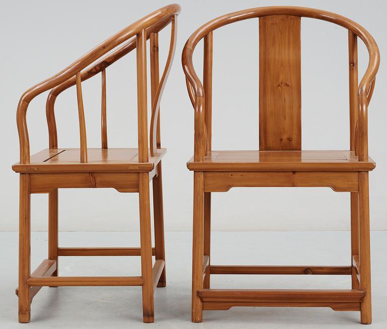 A pair of wooden horseshoeback armchairs, Qing dynasty.