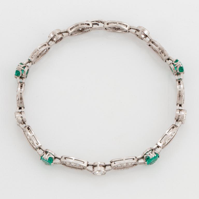 An 18K white gold bracelet set with faceted emeralds.