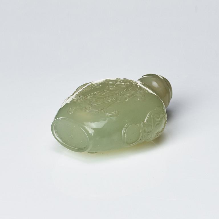 A Chinese carved nephrite snuff bottle with cover.