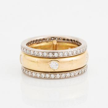 An 18K gold ring set with round brilliant-cut diamonds.