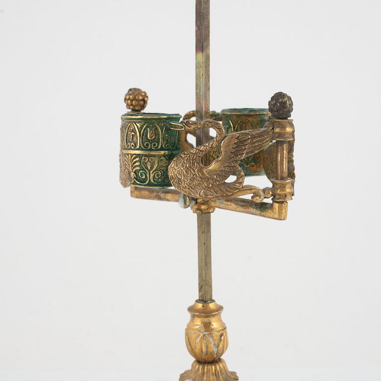 An Empire gilt bronze and tôle-peinte two-light reading lamp, early 19th century.