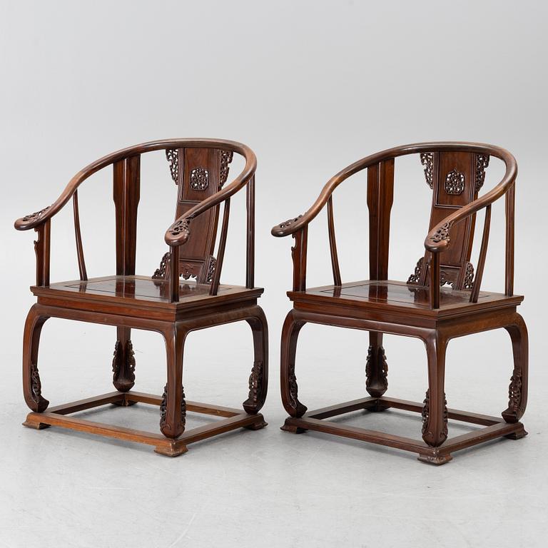 A pair of Chinese horseshoe-back hardwood armchairs, 1900s.