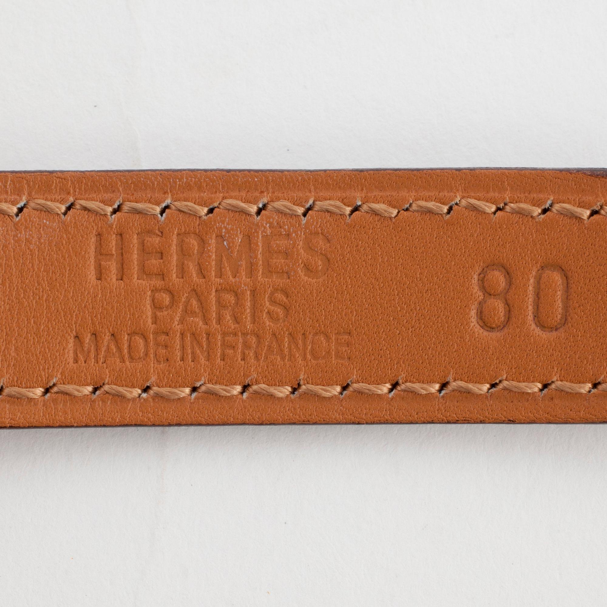 HERMÈS, a black leather belt.
