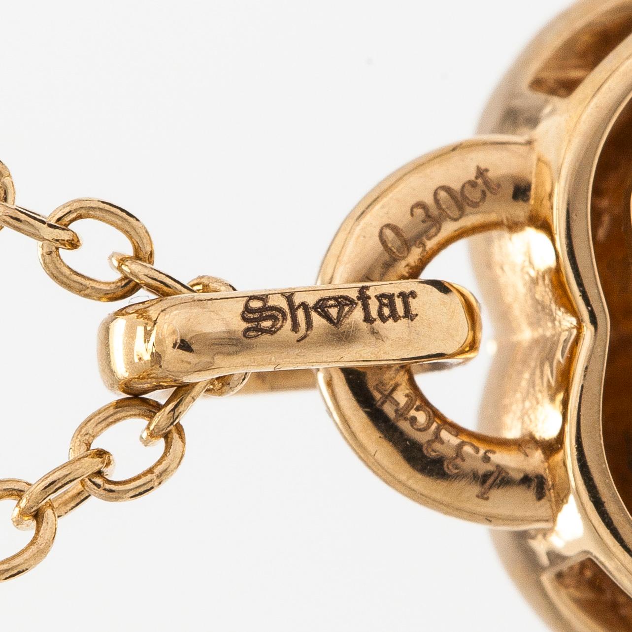 An 18K gold necklace, with a heart-shaped tanzanite and brilliant-cut diamonds.