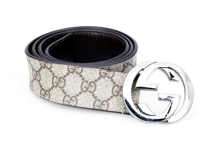 A monogram canvas belt by Gucci.